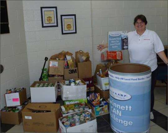 Barbara Runkle with all the food collected at Oakland Meadow School for the Holtkamp CAN Challenge