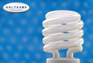 Compact fluorescent bulb with a blue background.